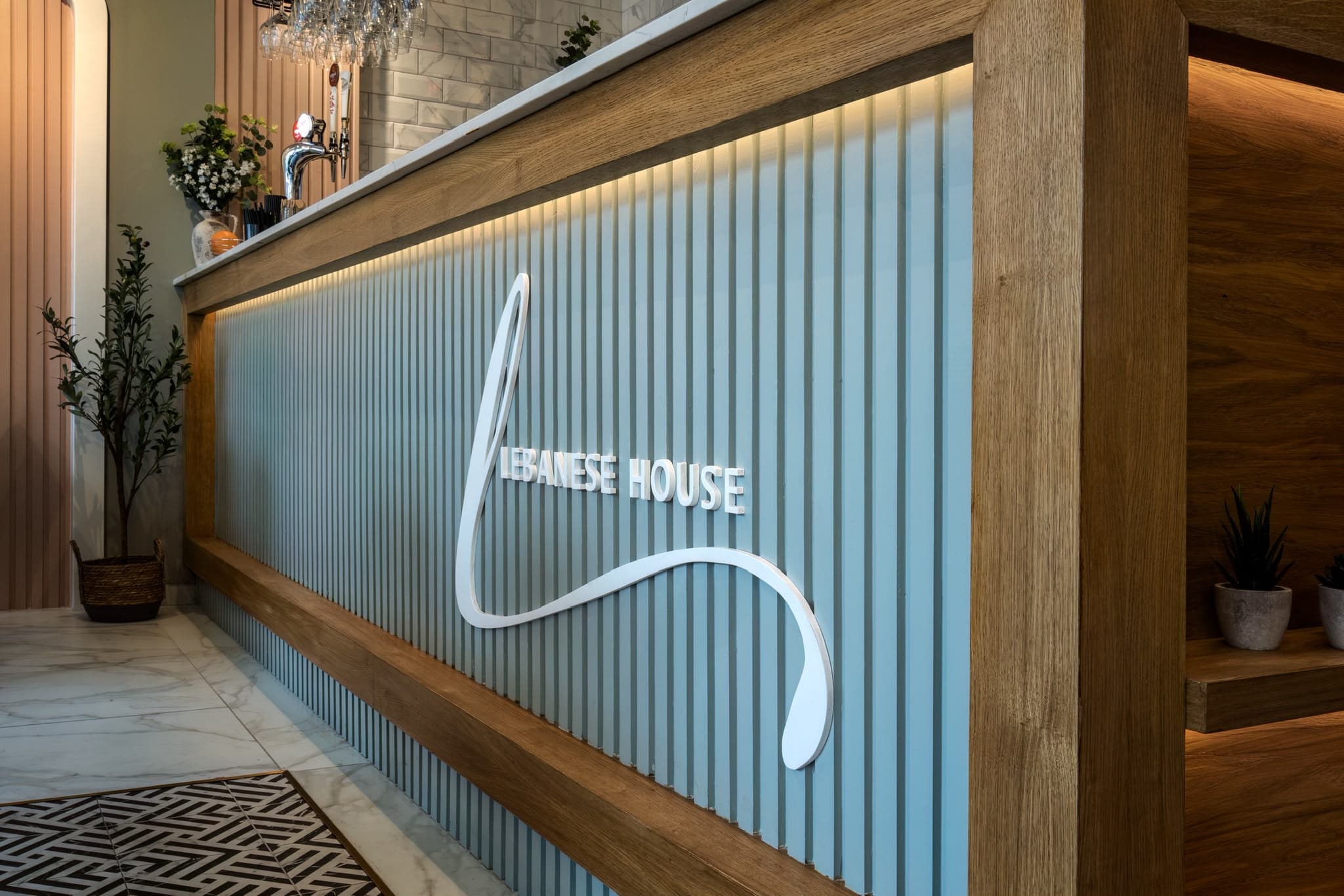 Lebanese House bar front with fluted panelling, oak frame and the restaurant logo