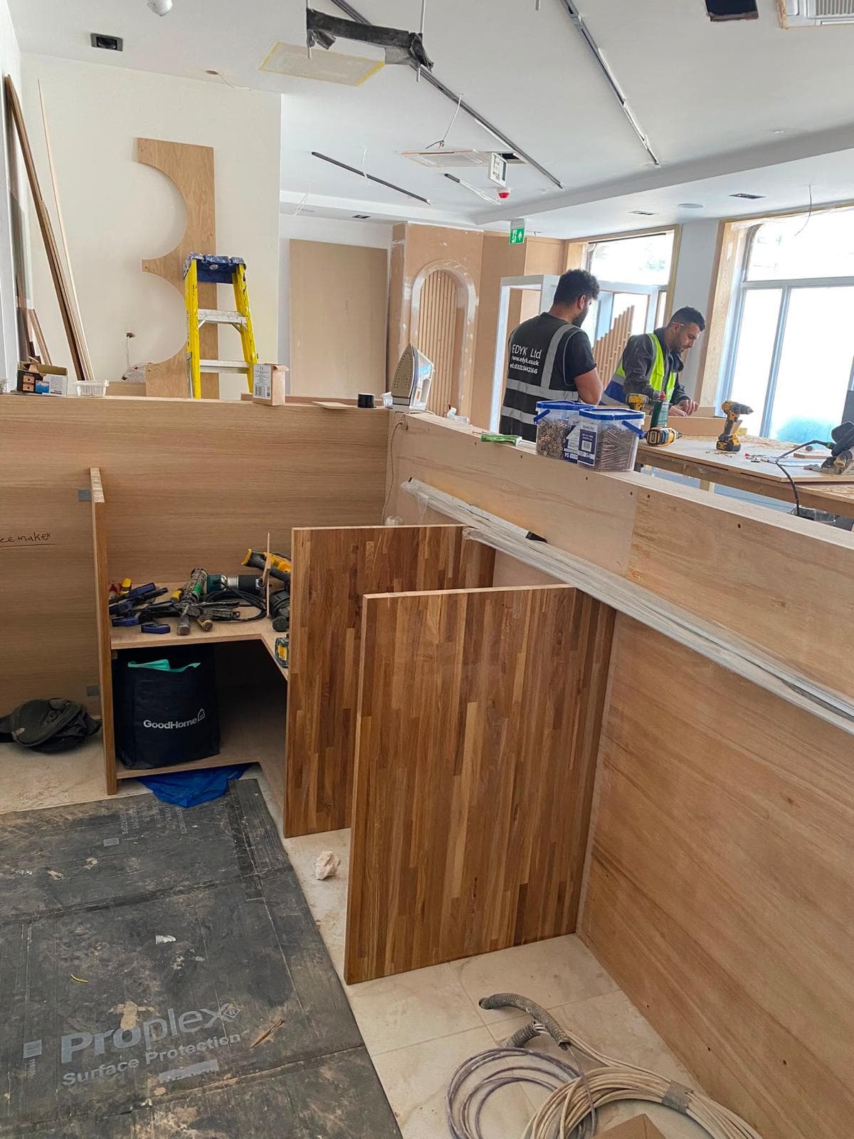 Bar joinery under construction at Lebanese House with oak panels and EDYK team members at work