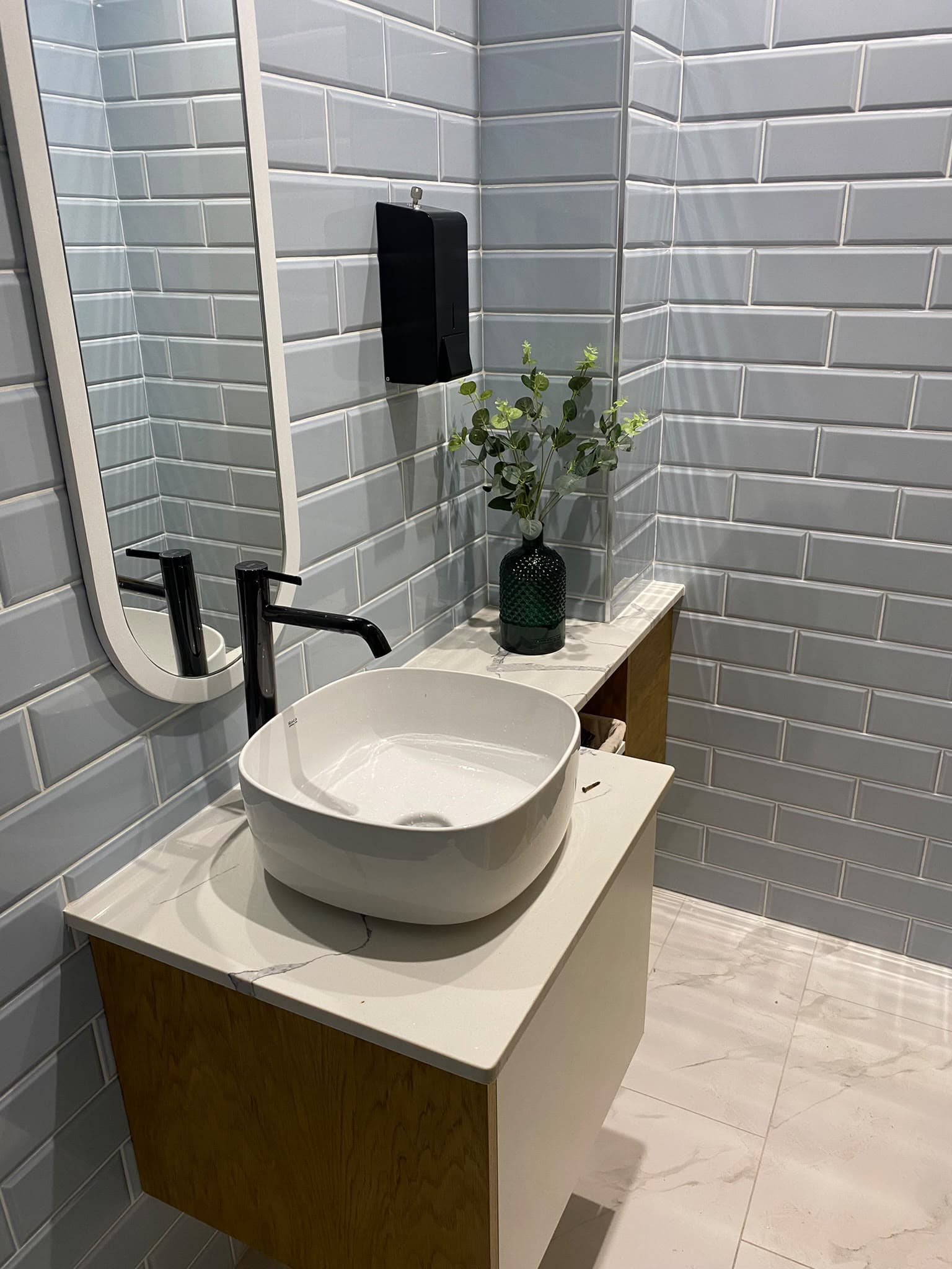 Lebanese House washroom with blue metro tiles, an oak vanity unit and a countertop basin